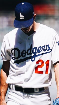 a dodgers baseball player walking on the field