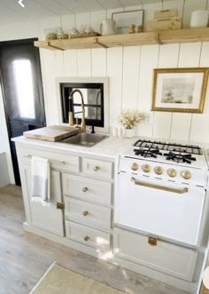 a white stove top oven sitting inside of a kitchen