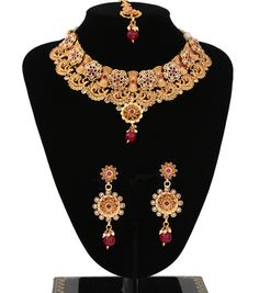 "Elegant gold Choker Necklace Set | Traditional jewelry decorated with AD CZ and synthetic ruby stones magnificent design Necklace Set | Indian Jewelry Set | comes with matching earrings and mang tikka | 1 x Necklace approx. 4.5 inches Collar-Wide . Back adjustable rope is attached. 1 x Pair of Earrings 2.8\" Length from top to bottom. *Adjustable & Appropriate for All Neck Sizes. Perfect for a bride in wedding or party wear jewelry set." Luxury Dual-tone Necklaces For Diwali, Gold Ruby Jewelry With Round Shape, Gold Ruby Round Jewelry, Gold Ruby Jeweled Necklaces, Gold Ruby Jeweled Necklace, Gold Jeweled Ruby Necklace, Gold Ruby Necklace With Intricate Design, Gold Ruby Kundan Necklace, Gold Ruby Temple Jewelry Sets