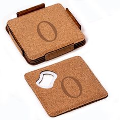 two cork coasters with the letter o on them, one has a computer mouse