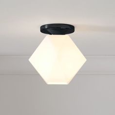 a white light hanging from the ceiling in a room