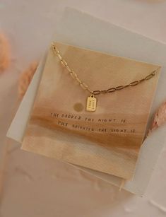 True Light Mini Tag Necklace The light shines in the darkness, and the darkness has not overcome it. John 1:5 Double-sided tag on dainty paperclip chain Tag size: 5x7mm Adjustable 16-18" 14kt Gold Plated Hypoallergenic Tarnish + Water Resistant Details • Made in United States Danty Necklace, Light Shines In The Darkness, John 1 5, In The Darkness, The Darkness, 14kt Gold, Tag Necklace, Paper Clip, Jewelry Ideas