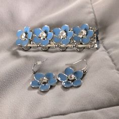 Brand New Blue Flower With Gemstone Accent Earrings & Bracelet Silver Flower-shaped Metal Jewelry Sets, Blue Flower Shaped Jewelry For Party, Blue Flower-shaped Formal Jewelry, Formal Silver Flower Jewelry Sets, Formal Silver Flower-shaped Jewelry Sets, Blue Flower-shaped Wedding Jewelry, Light Blue Flower-shaped Jewelry With Matching Earrings, Adjustable Light Blue Jewelry For Party, Elegant Blue Flower Bracelets