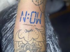 a person with a tattoo on their arm that says n o nnqn