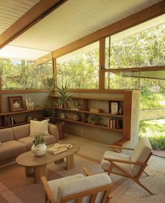 a living room filled with furniture and lots of windows