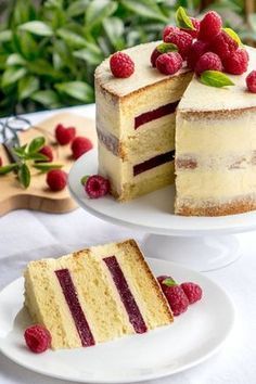 two pieces of cake with strawberries and whipped cream on the top one slice is cut in half