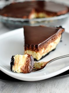 a slice of chocolate cheesecake on a plate with a fork