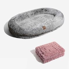 two dog beds with fur on them, one is pink and the other is grey