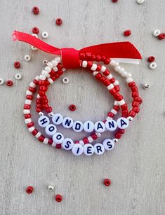 two red and white bracelets with the word indiana spelled out in letters on them