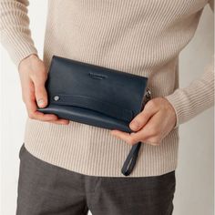 A leather men's clutch is an indispensable item for a modern business man.The accessory is made by hand. Strong genuine leather was used for tailoring.Inside the accessory there are two large compartments and 10 pockets for cards and business cards. There is also a zipper pocket on the front outer wall of the accessory for coins and other small items.The button clutch closes. For convenience, the accessory is equipped with a removable leather loop, which allows you to wear the accessory on the w Business Clutch Wallet With Coin Pocket, Business Clutch Wallet With Card Slots, Modern Business Bags With Card Slots, Leather Business Wallet Pouch, Business Leather Wallet Pouch, Modern Business Clutch With Card Slots, Bifold Leather Office Bag, Modern Bifold Clutch For Business, Classic Blue Business Wallets