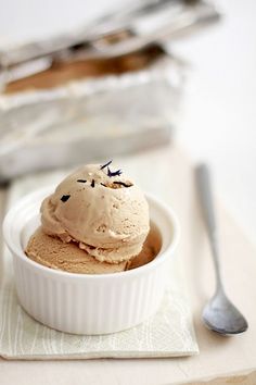 a bowl filled with ice cream next to a spoon