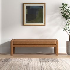 an empty room with a bench and potted plant