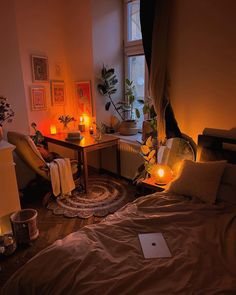 a bedroom with candles on the floor and a bed in front of a large window