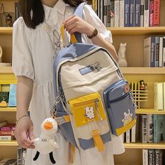 This Kawaii Backpack With Pins And Keychain is the perfect statement piece for those seeking to express their individuality. Crafted with a vibrant and whimsical color palette, this exclusive accessory is sure to turn heads with its chic, playful style and eye-catching details. The included pins and keychain add the perfect touch for an unforgettable look. Backpack With Pins, Buckle Backpack, Blue College, Kawaii Backpack, Student Book, Backpack Decoration, Student Bag, College Backpack, School Bags For Girls