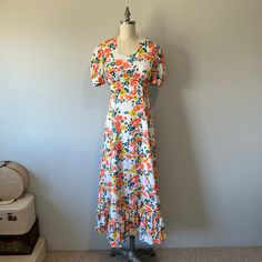 "A lovely 70s vintage dress in a vibrant floral pattern. In perfect condition. The zipper works just fine it's just a little small for my mannequin.  Size: XS/S Tag - none Era - 70s  Material - polyester, blend, nylon zipper Bust - 33\" Waist - 26\" empire upper waist Hips - 36/37\" Length - 53.5\" Washing - cold delicate wash in laundry bag. Hang to dry Floral Boho Dress / Long Spring Flower Dress / Cottagecore Style / Vintage 70s Dress / Garden Party Dress / Vacation Wear" Fitted A-line Vintage Dress With Floral Print, Vintage Floral Print Midi Dress With V-neck, Retro V-neck Midi Dress With Floral Print, Orange Vintage Dress For Spring, Spring Garden Party Dress With Retro Print, Retro Spring Maxi Dress For Garden Party, Retro Print Dress For Garden Party, Retro Maxi Dress For Spring Garden Party, Retro Fitted Floral Dress For Spring