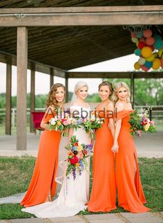 the bride and her four bridesmaids pose for a photo in their orange dresses