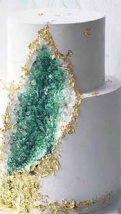 a white cake with gold and green frosting