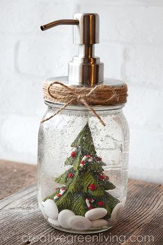 a christmas tree in a glass jar with soap dispenser on the top