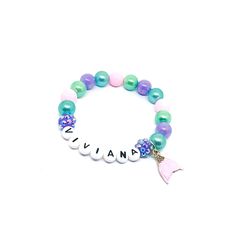 This adorable stretchy bracelet features an enameled mermaid tail charm with rhinestone accents, alphabet beads, resin rhinestone beads and 10mm purple, pink, aqua blue and blue green acrylic beads double strung with durable stretch floss cord. The shade of pink on the tail varies a little between batches. The pink beads used will match the tail. Enter the one name you would like on your bracelet in the personalization box. Your bracelet will arrive in an organza bag making it ready to give as a Purple Stretch Bracelet With Letter Beads For Birthday, Purple Letter Beads Stretch Bracelet For Birthday, Adjustable Purple Beaded Name Bracelet, Little Mermaid Bracelet, Mermaid Tail Bracelet, Mermaid Names, Medical Bracelet, Alphabet Beads, Cardboard Jewelry Boxes