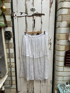 Antique French white linen skirt with embroidered lace hem size M. 100% Linen top section. 100% net lower section. Waist is adjustable with tie, linen top section and embroidered net lower section - lovely skirt. It is see through so would be suitable with a slip underneath or over a dress to layer up. Size:  Waist: adjustable with tie; Length: 32 inches. Weight: allow up to 1 kg once packed. Good condition. Lace Skirt With Floral Embroidery, White Broderie Anglaise Cotton Skirt, Summer Broderie Anglaise Skirt For Daywear, White Cotton Skirt With Broderie Anglaise, White Lace Bottoms With Floral Embroidery, Summer Lace Skirt With Embroidery, Summer Embroidered Lace Skirt, Long Lace Skirt With Floral Embroidery, White Bottoms With Cutwork Hem For Summer