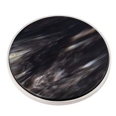 an image of a black and white marble surface on a round metal plate with silver trim