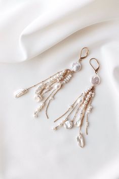 ❄️ Production times have now been extended due to the holidays, please check the estimated delivery date in your cart before ordering. If you need an order sooner than is stated please contact me to see if it will be possible. ❄️ Elevate your bridal ensemble with these exquisite long dangly boho luxury earrings. Handcrafted with meticulous care and quality materials, these earrings feature a stunning combination of 14k filled gold chain and a curated mix of freshwater pearls, ensuring a unique a Dangling Beads Bridal Earrings For Wedding, Elegant Long Drop Chandelier Earrings With Dangling Charms, Wedding Bridal Earrings With Dangling Beads, Wedding Bridal Dangle Earrings With Beads, Delicate Dangling Beads Earrings For Wedding, Long Drop Pearl Earrings With Dangling Beads For Wedding, Beaded Dangle Earrings For Wedding, Beaded Dangle Bridal Earrings For Wedding, Pearl Chandelier Earrings With Dangling Beads For Wedding