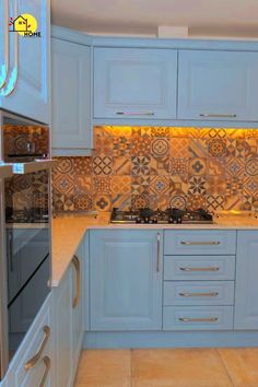 a kitchen with blue cabinets and tile backsplash