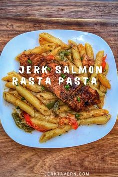 a white plate topped with pasta and meat covered in sauce on top of a wooden table