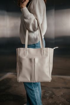 Description: This elegant beige leather tote bag is the perfect blend of style and functionality. Handcrafted from high-quality genuine leather, this bag is designed to be both durable and fashionable. The bag features a spacious main compartment, along with six pockets to keep all your essentials organized. With its sleek design and premium materials, this leather tote is ideal for everyday use, whether you're heading to work, running errands, or going out with friends. Specifications: Height: 30 cm (11.8 inches) Width: 28 cm (11 inches) Depth: 12 cm (4.7 inches) Number of compartments and pockets: 6 Material: Genuine floater leather Hardware: Metal fittings One large main compartment Two additional front pockets One zippered pocket at the back Materials: High-quality genuine floater leat Beige Tote Shoulder Bag With Zipper, Beige Shopping Bag With Zipper Pocket, Modern Cream Shoulder Bag With Zipper Closure, Cream Shoulder Bag With Zipper For On-the-go, Modern Cream Bag With Zipper Closure, Modern Cream Bags With Zipper Closure, Everyday Beige Shoulder Bag With Zipper Closure, Cream Shopping Bag With Zipper Closure, Cream Satchel With Zipper For Daily Use