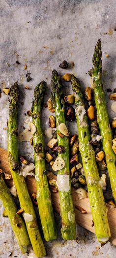 asparagus spears with almonds on a cutting board