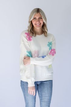 Are you ready to brighten everyone's day with our Flower Power Daisy Print Sweater!? This white knit sweater has the most adorable pastel daisy print that is perfect to help you transition from Winter to Spring. This sweater is perfectly light weight and detailed with a ribbed contrast hem around the round neckline and arm cuffs. Pair it with jeans on a chilly day, or with shorts for the perfect Spring look! - White knit sweater with pastel daisy print - Light weight knit sweater - Ribbed contra White Trendy Sweater With Ribbed Cuffs, Trendy White Sweater With Ribbed Cuffs, Trendy Spring Crew Neck Sweater, Trendy Crew Neck Sweater For Spring, Trendy Floral Print Crew Neck Sweater, White Spring Sweater With Ribbed Cuffs, White Ribbed Cuffs Sweater For Spring, White Sweater With Ribbed Cuffs For Spring, Spring Soft Knit Crew Neck Sweater