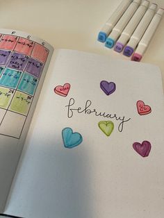 an open planner with hearts and the word february written in cursive writing