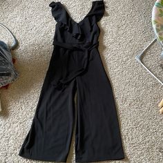 Super Cute - Never Worn. Bought At A Little Boutique But I Just Never Reach For It. Flattering With Tie Waist. Hits Mid Calf No Size On The Tag But Fits Like A Standard Medium/Size 8 Casual Black Jumpsuits And Rompers With Ruffles, Sleeveless Black Jumpsuit With Ruffles, Casual Black Jumpsuit With Ruffles, Sleeveless Black Ruffled Jumpsuits And Rompers, Black Sleeveless Ruffled Jumpsuit, Sleeveless Black Ruffled Jumpsuit, Black V-neck Jumpsuits And Rompers With Ruffles, Black V-neck Jumpsuit With Ruffles, Black Ruffled Jumpsuits And Rompers For Work