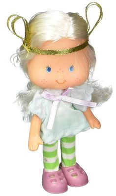 a doll with blonde hair wearing green and white striped socks, pink shoes and a gold crown on her head