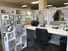 an office cubicle with pictures on the wall and desks in front of it