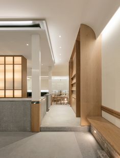 the interior of a modern house with wood and stone accents on the walls, concrete flooring and built - in shelving