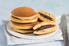 a stack of pancakes sitting on top of a white plate