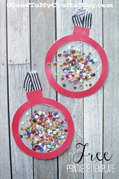 two christmas ornaments made out of paper and colored beads on top of a wooden table