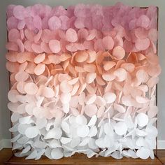 an art piece made out of pink and white paper flowers