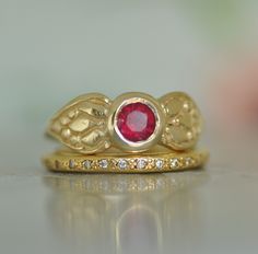 "Gold Ruby Ring Set, Wedding Ruby and Diamonds Set, 14k Gold Diamond Ring for Women, Round 5 m\"m Ruby, eternity Diamond Ring, Solid Gold Ring Set of 14k gold Ruby ring and gold eternity Diamond ring. Round red, beautiful 5 m\"m Ruby, sets on the center of the engraved gold dainty ring. Two unique leaf are engraved on the two sides of the round red Ruby, each leave has small engraved details inside. The second ring is 14k solid gold eternity ring with small Diamonds set all around the ring. The two rings are 14k solid yellow gold. This set of rings can be an engagement set, that is defiantly unique and exclusive! These rings are handmade, engraved by me.  I made this gold Ruby  ring to be the perfect frame for the unusual red Ruby which serves as the center stone. The Rings Ruby Ring Set, 14k Gold Ruby Ring, Gold Ruby Ring, Eternity Diamond Ring, Diamond Ring For Women, Ruby Ring Gold, Eternity Ring Gold, Engagement Sets, Solid Gold Ring