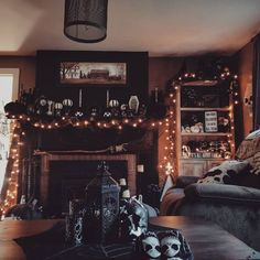 the living room is decorated for halloween with lights and decorations on the fireplace mantel