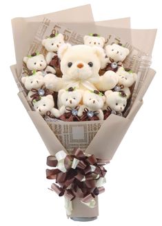 a bunch of teddy bears wrapped in brown paper and tied to a vase with ribbon