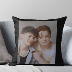 two young men are posing for the camera throw pillow