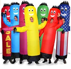 group of people dressed in costumes standing next to each other with large tubes on their heads