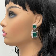 The Renee Emerald & Diamond Earrings are a unique and luxurious heritage pair with royal green emeralds and diamonds set in white gold. Gemstones Type: EmeraldGemstones Shape: RectangularGemstones Weight: 25.01 ctGemstones Color: Green Diamonds Shapes: Round & Marquise Total Diamonds Weight: 3.01 ctDiamonds Color: H - J Diamonds Clarity: VS - SI (Very Slightly Included - Slightly Included) Metal: 14K Gold Metal Wt: 17.4 gms Setting: Prong Set Price Quoted may be negotiable. Please contact us to Luxury Green Diamond Earrings With Prong Setting, Green Diamond Earrings With 17 Jewels For Formal Events, Green Diamond Earrings With 17 Jewels For Formal Occasions, Formal Green Diamond Gemstone Earrings, Luxury Green Diamond Earrings For Wedding, Formal Green Gemstone Diamond Earrings, Luxury Green Emerald Diamond Earrings, Green Hand Set Diamond Earrings, Green Hand-set Diamond Earrings