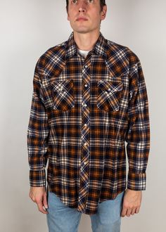 "For sale is a vintage western shirt. Slight taper to waist, nice midweight flannel. Cotton poly blend. Men's size XL Measurements taken laid flat: Pit-to-pit chest width: 25\" Waist width at minimum taper: 23.5\" Length from top of shoulder (at collar) to shortest point at bottom (front and rear tails not included): 29\" Sleeve length from edge of shoulder: 24.5\" Model is 6'5\" 180lb, wears the following sizes: Dress shirt: 15.5\" neck, 36.5\" sleeve Suit jacket: 40L - 42L depending on cut Pan Retro Western Shirt For Fall, Retro Long Sleeve Shirt For Ranch, Western Style Plaid Flannel Shirt For Ranch, Western Plaid Flannel Shirt For Rodeo, Western Style Long Sleeve Plaid Flannel Shirt, Cheap Vintage Brown Flannel Shirt, Brown Plaid Flannel, Brown Vintage Flannel Shirt With Button Closure, Vintage Brown Flannel Shirt