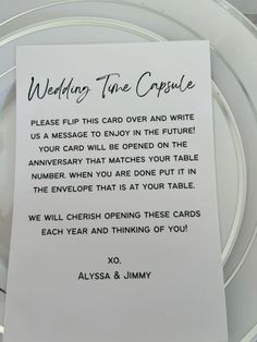 a white plate topped with a card and a piece of paper