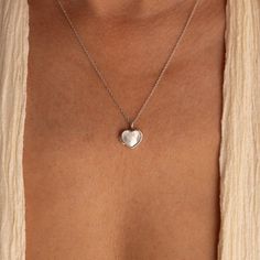 Our Mother of Pearl Heart Locket combines both sentimentality and elegance. Insert any picture that is close to your heart in the dainty locket charm and allow that image to bring you peace whenever you need it. The delicate chain and pendant are perfect for layering with your other meaningful pieces to create a nostalgic jewelry look. SKU: RR-NR171 Product Details Material: High Quality Solid 925 Sterling Silver Finish: Sterling Silver ∙ 18K Gold Locket comes without a photo. Photo insertion se Couples Lockets Necklaces, Dainty Open Heart Locket Necklace, Dainty Heart Pendant Locket Necklace With Delicate Chain, Dainty Open Heart Locket Necklace With Heart Charm, Dainty Heart Charm Locket Necklace, Double Heart Locket Charm Necklace For Keepsake, Dainty Heart Pendant Locket Necklace With Charm, Dainty Heart Locket Necklace With Charm, Dainty Double Heart Locket Necklace With Charm