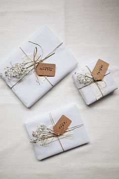 three white napkins with tags tied to them