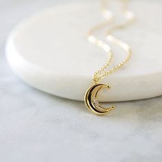 "Beautiful and lovely gold crescent moon necklace made of tiny cubic stone gold crescent moon with skinny gold plated brass chain. Soft and warm looking necklace is good for yourself or gift ! Your necklace will ship in a rudiana gift box. ♥Length 15\" - 20\" ♥Pendent 1/2\" x 1/2\" ♥Gold plated over brass / Cubic Zirconia ♥ Delivery Time Fast shipping within 1 - 3 days ♥ See more Rudiana Accessories Rudiana.etsy.com" Dainty Gold Half-moon Charm Necklace, Delicate Gold Crescent Necklace, Gold Crescent Charm Necklace With Delicate Chain, Dainty Necklace Gold, Crescent Moon Necklace Gold, Gold Crescent Moon, Gold Moon Necklace, Fancy Jewelry Necklace, Casual Necklaces